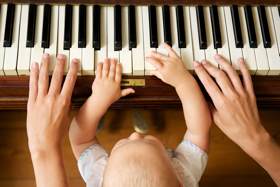 Baby Learning To Play Piano With Mother